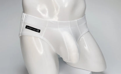 White WildmanT swim brief on a mannequin, featuring a contoured front pouch and a black branded label on the hip.