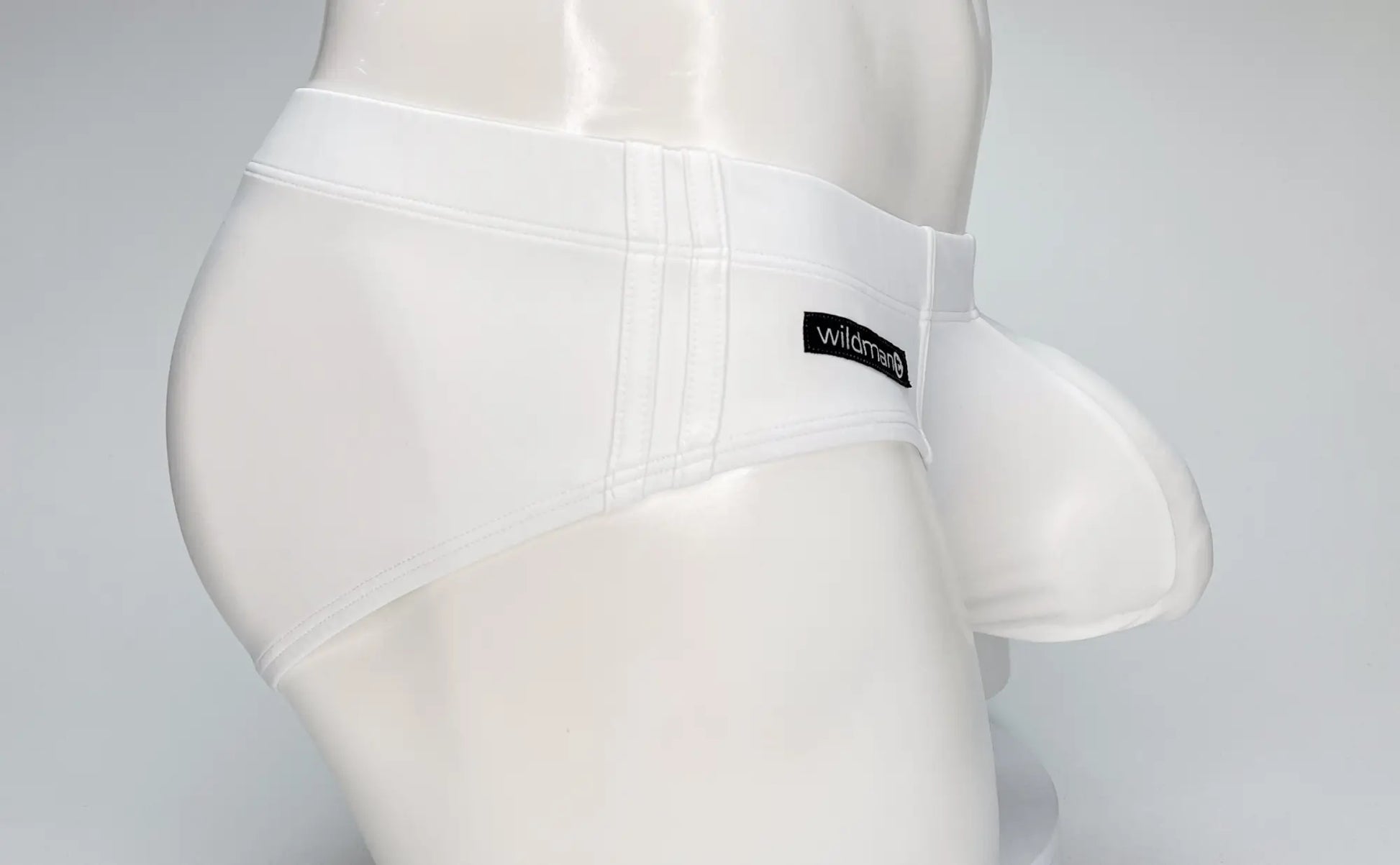 Wildman white big boy pouch swim brief featuring smooth glossy fabric and supportive pouch design for men