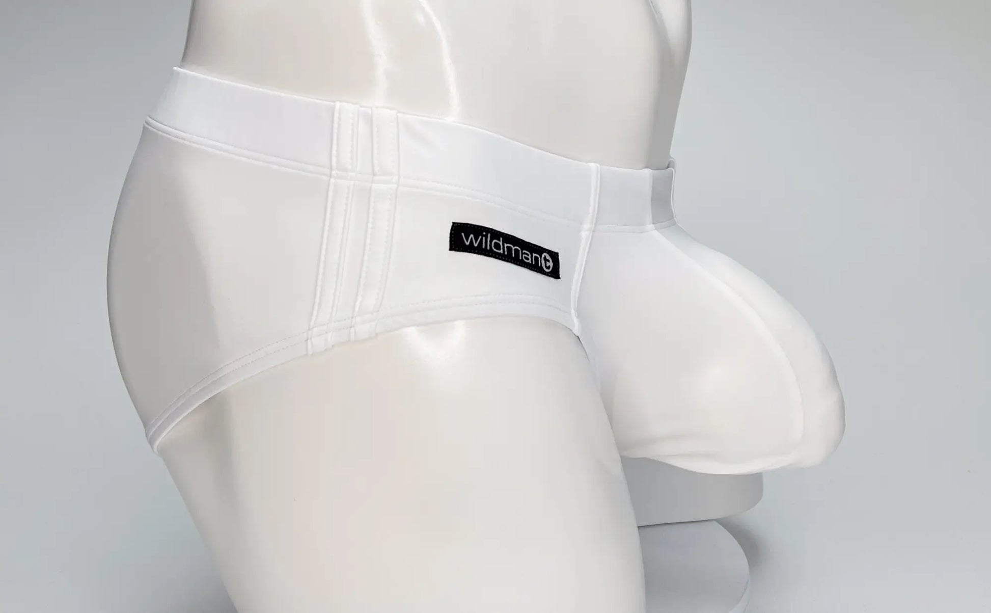 Wildmant big boy pouch swim brief in white featuring glossy form-fitting design and a prominent pouch for men