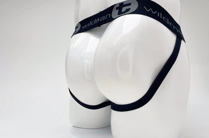 Black elastic waistband with wildman branding and stylized t logo on wildmant cotton big boy pouch stripe jockstrap