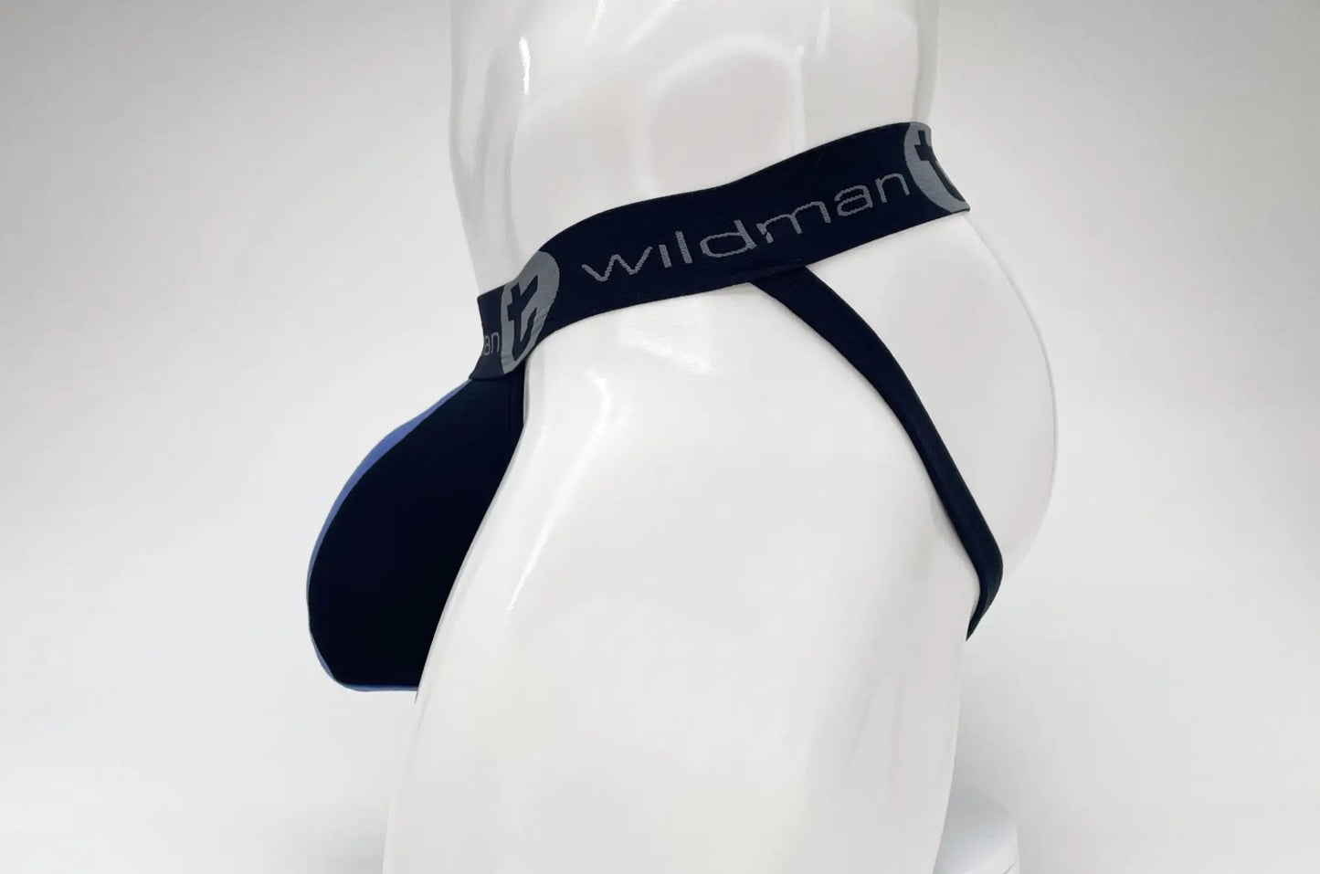 Black wildman brand thong with smooth stretchy fabric and subtle gray logo on waistband for wildmant cotton jockstrap