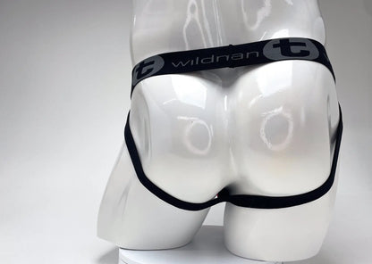Black elastic waistband with wildman t branding in white on a red and black cotton big boy pouch stripe jockstrap