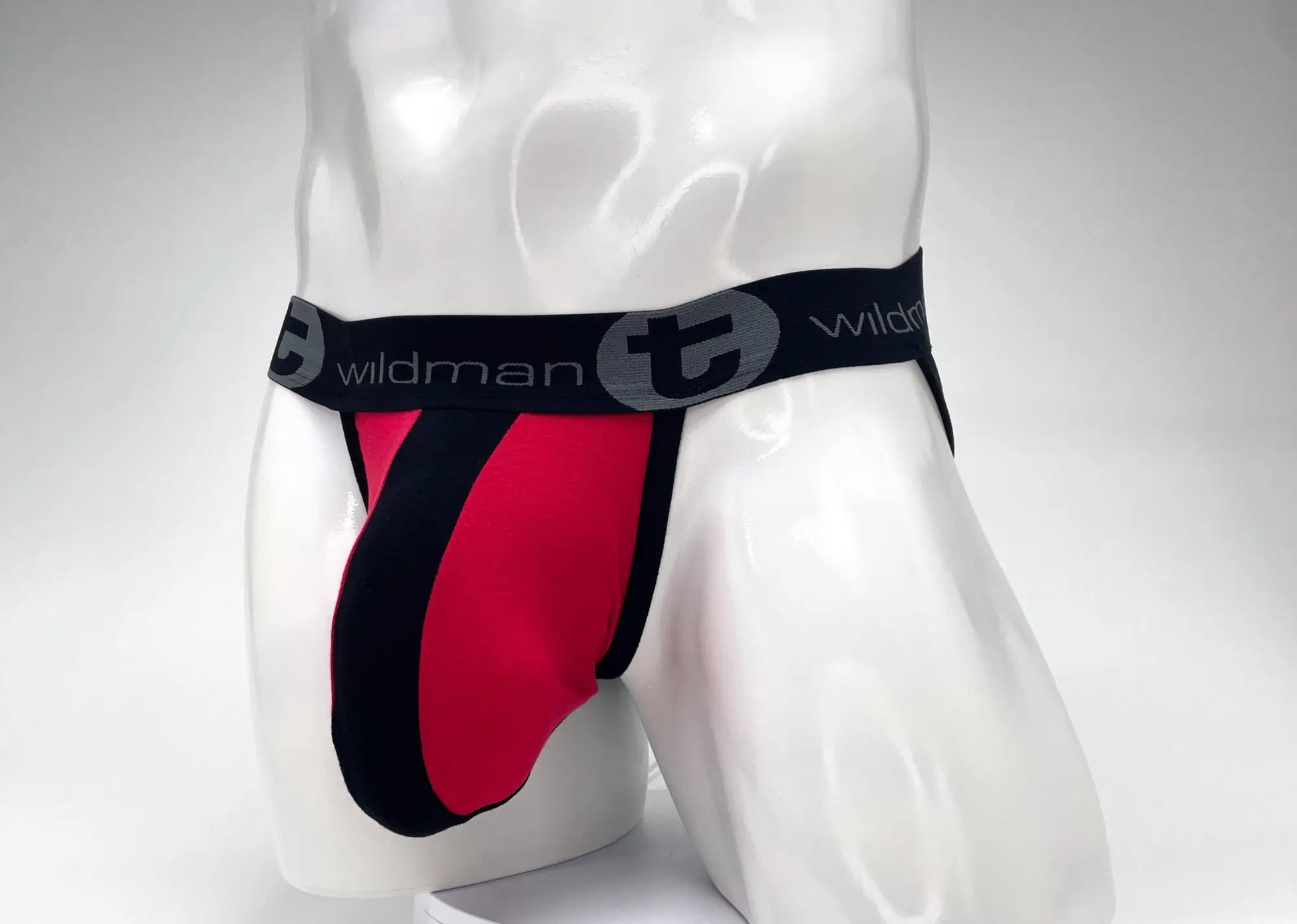 Red and black cotton wildmant big boy pouch stripe jockstrap with branded elastic waistband shown from the front