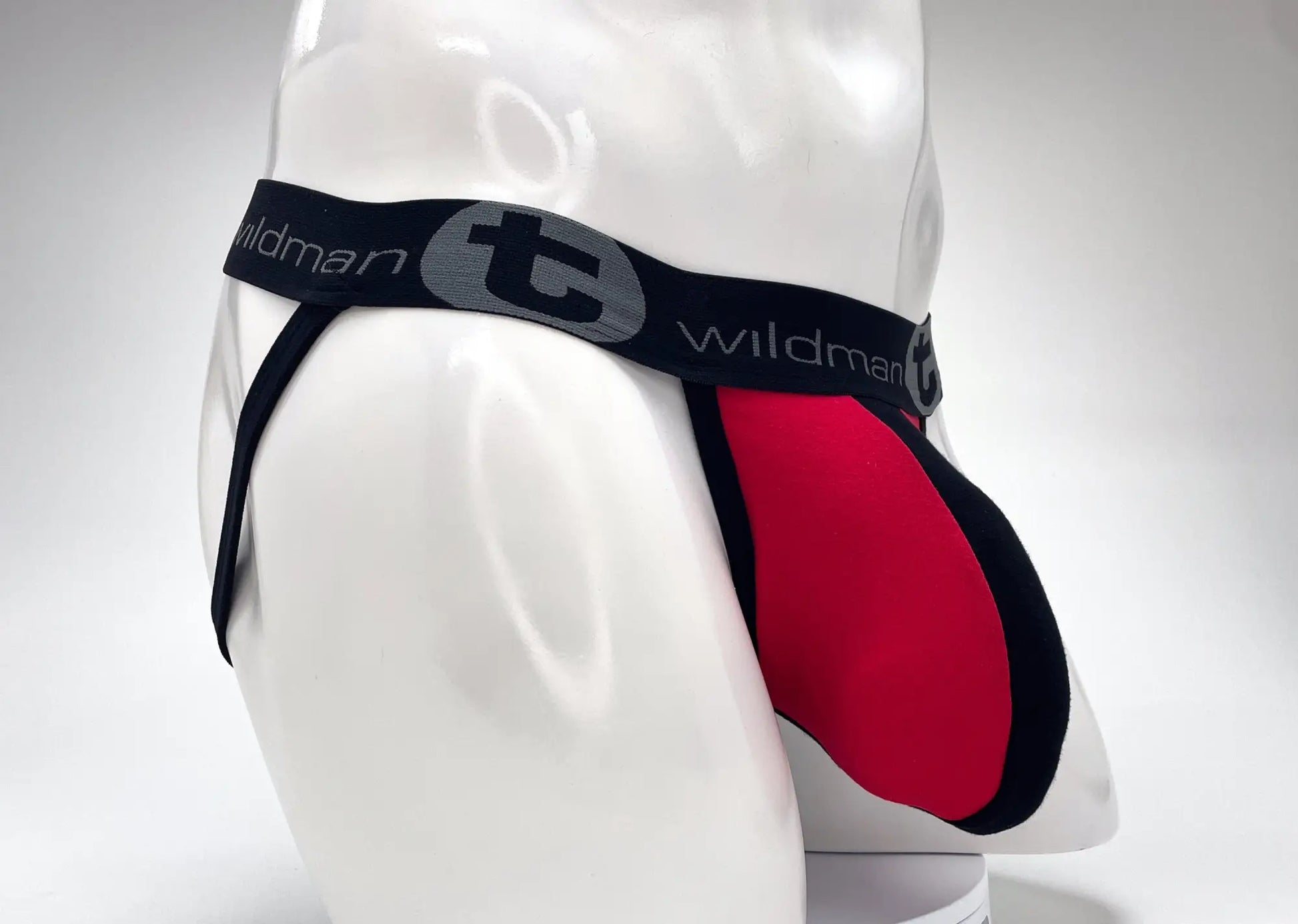 Wildmant cotton big boy pouch stripe jockstrap in red and black with gray logo waistband front view