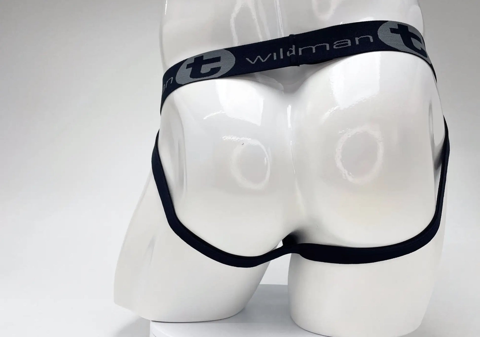 Black elastic waistband with wildman branding on white mannequin of wildmant cotton big boy pouch stripe jockstrap royal blue baby blue