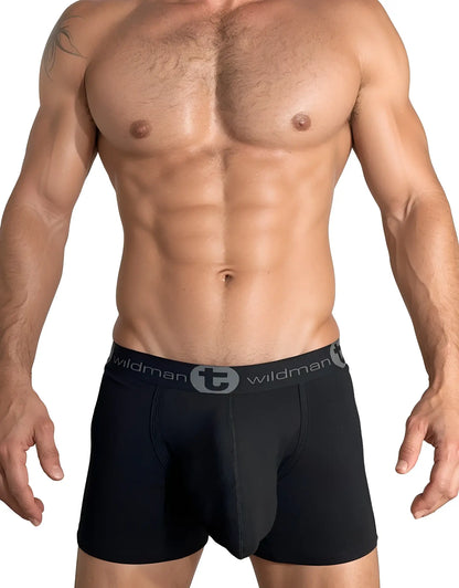 Muscular man wearing black WildmanT boxer briefs with a grey logo waistband and a contoured pouch design.