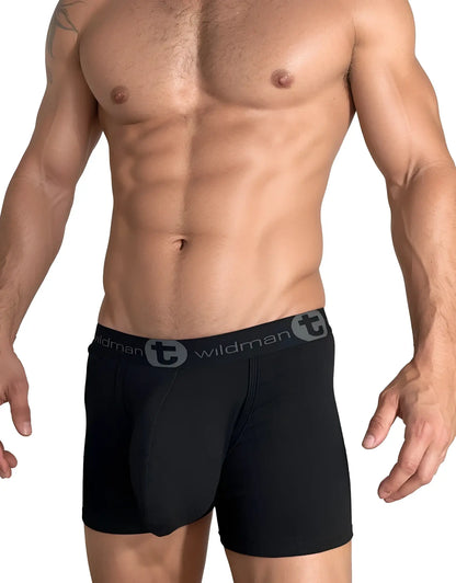 Muscular man wearing black WildmanT cotton boxer briefs with a 5-inch inseam and branded elastic waistband.