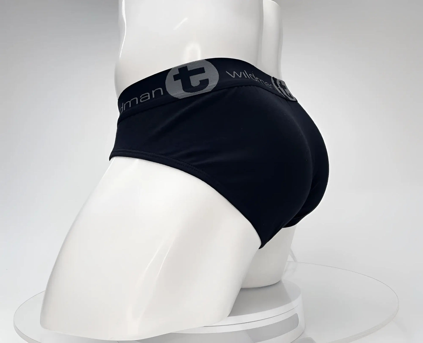 Black men’s cotton briefs with a gray elastic waistband featuring wildman logo and lettering in wildmant cotton monster cock brief black