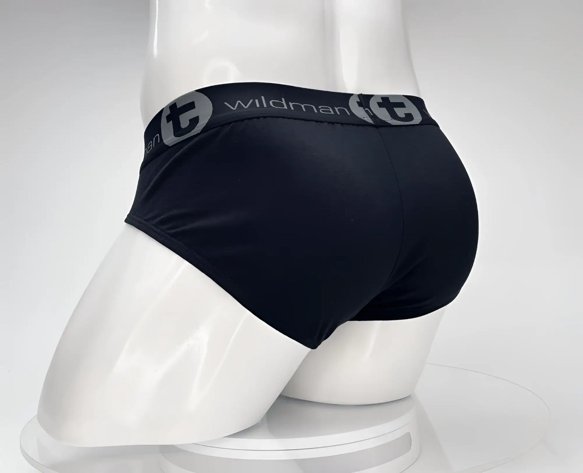 Black men’s cotton briefs with gray elastic waistband featuring wildman brand logo and circular t emblem