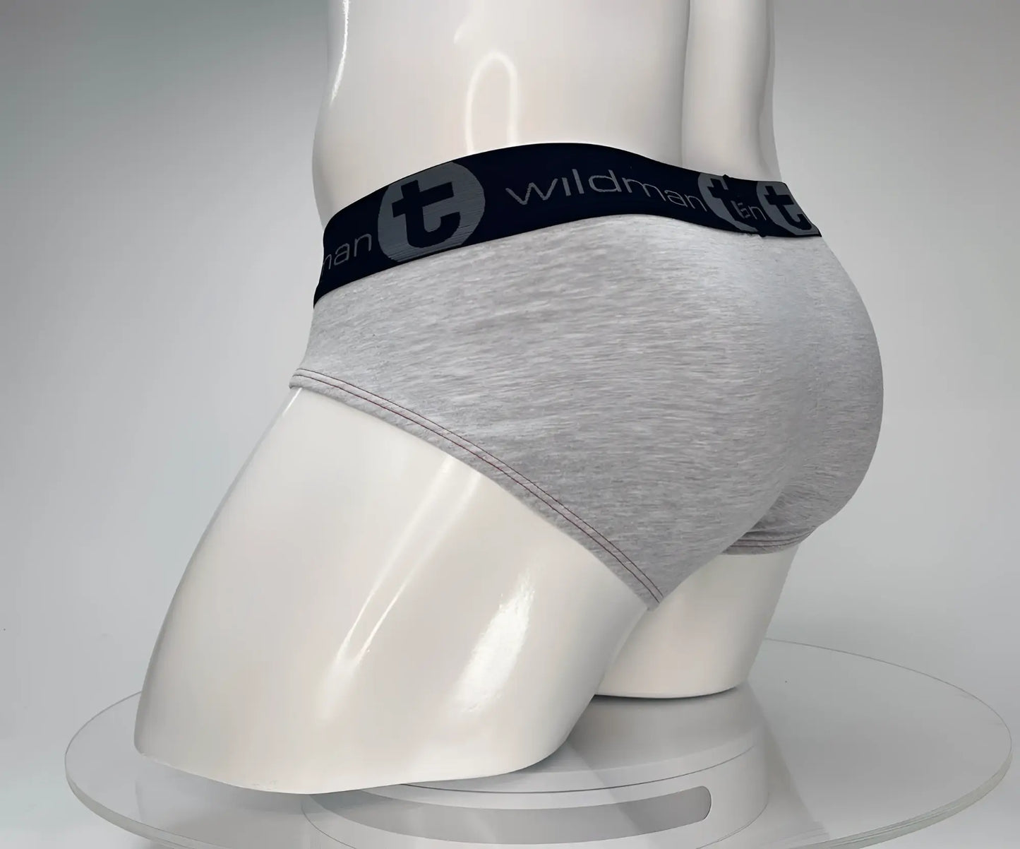 Gray heathered cotton briefs with a black elastic waistband featuring the wildman brand logo in red and gray