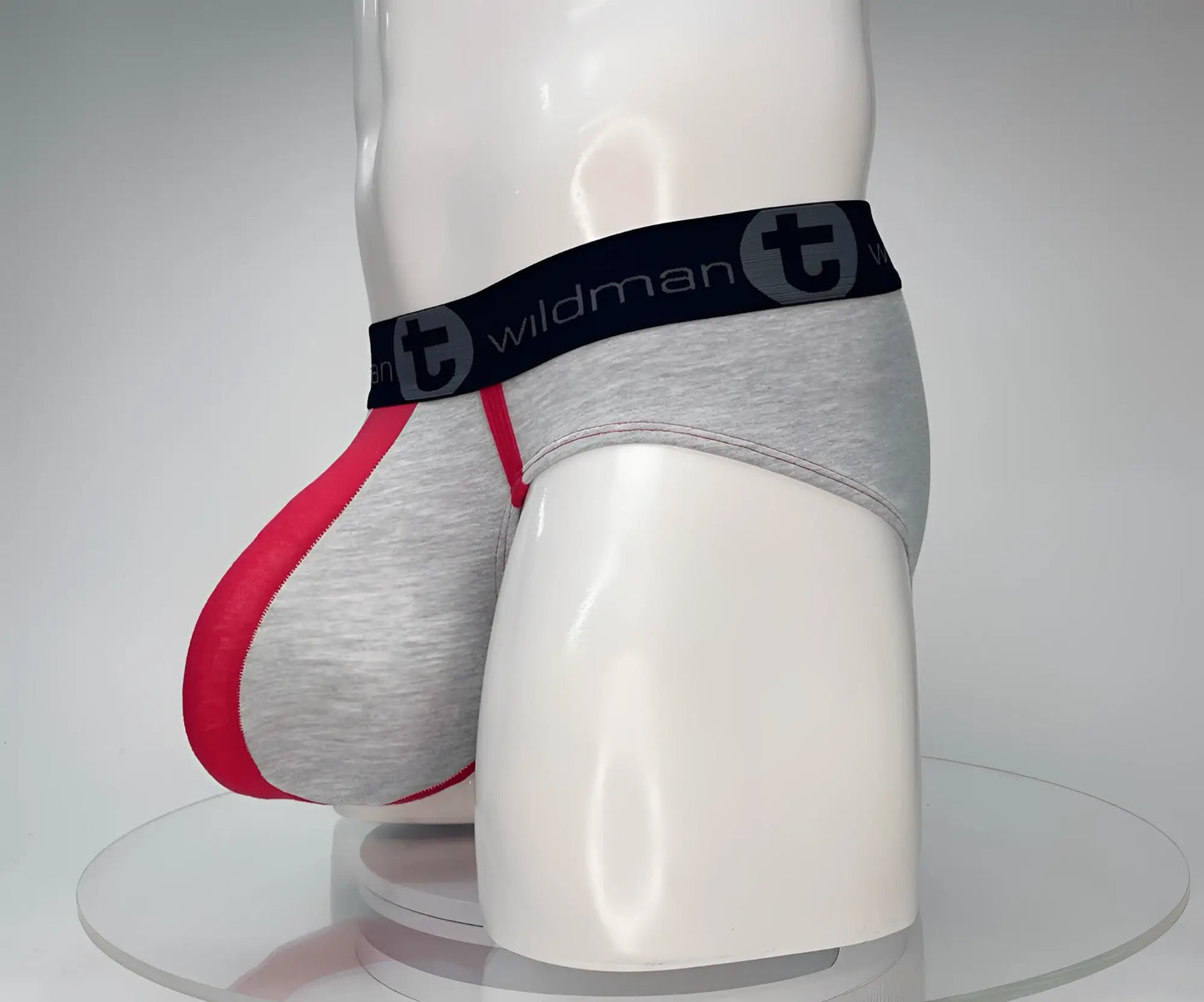 Gray and red cotton men’s briefs with a black waistband featuring the wildman brand logo wildmant cotton monster cock brief