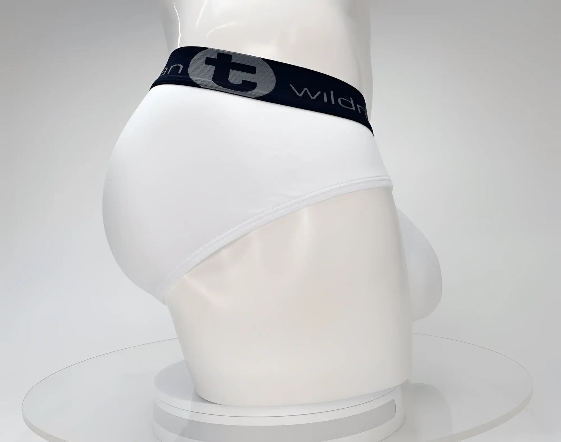 White cotton briefs with black elastic waistband featuring wildmant cotton monster cock brief logo