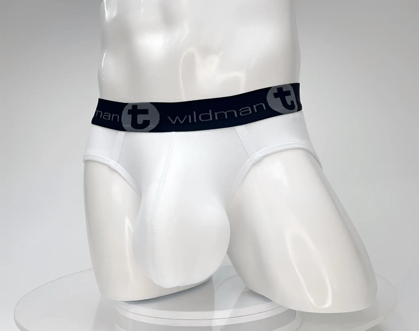 White men’s cotton briefs with black elastic waistband and gray wildman logo from wildmant cotton monster cock brief