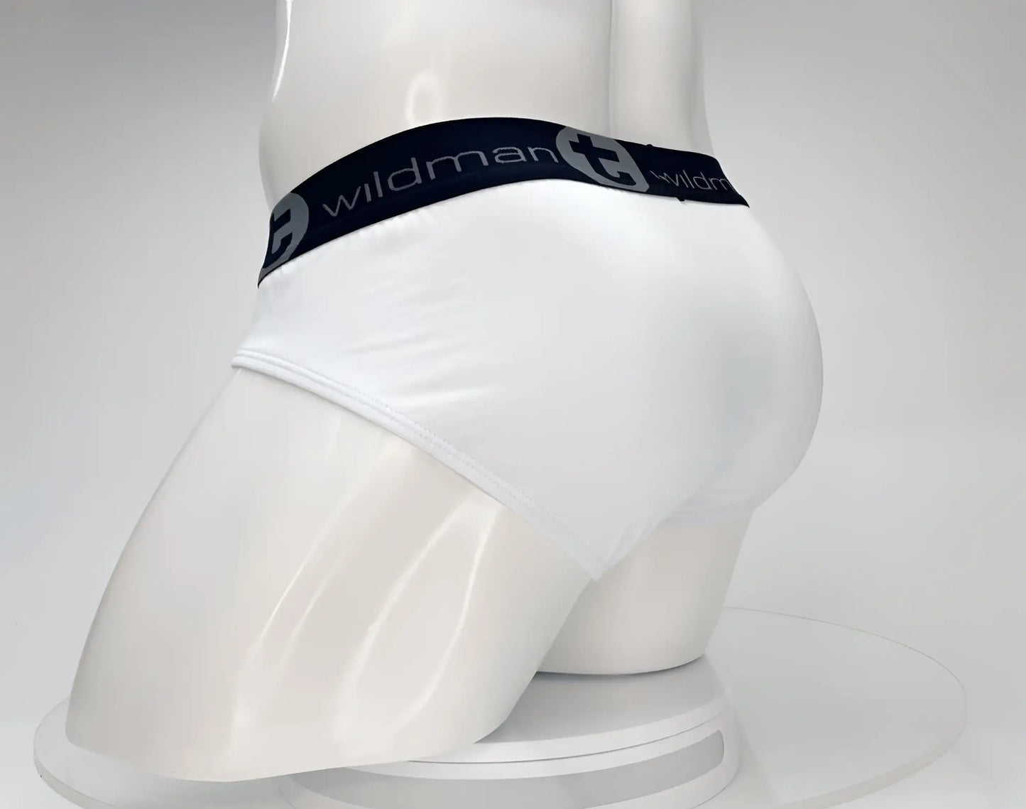 White men’s cotton briefs with black elastic waistband featuring wildman brand logo wildmantec monster cock brief white