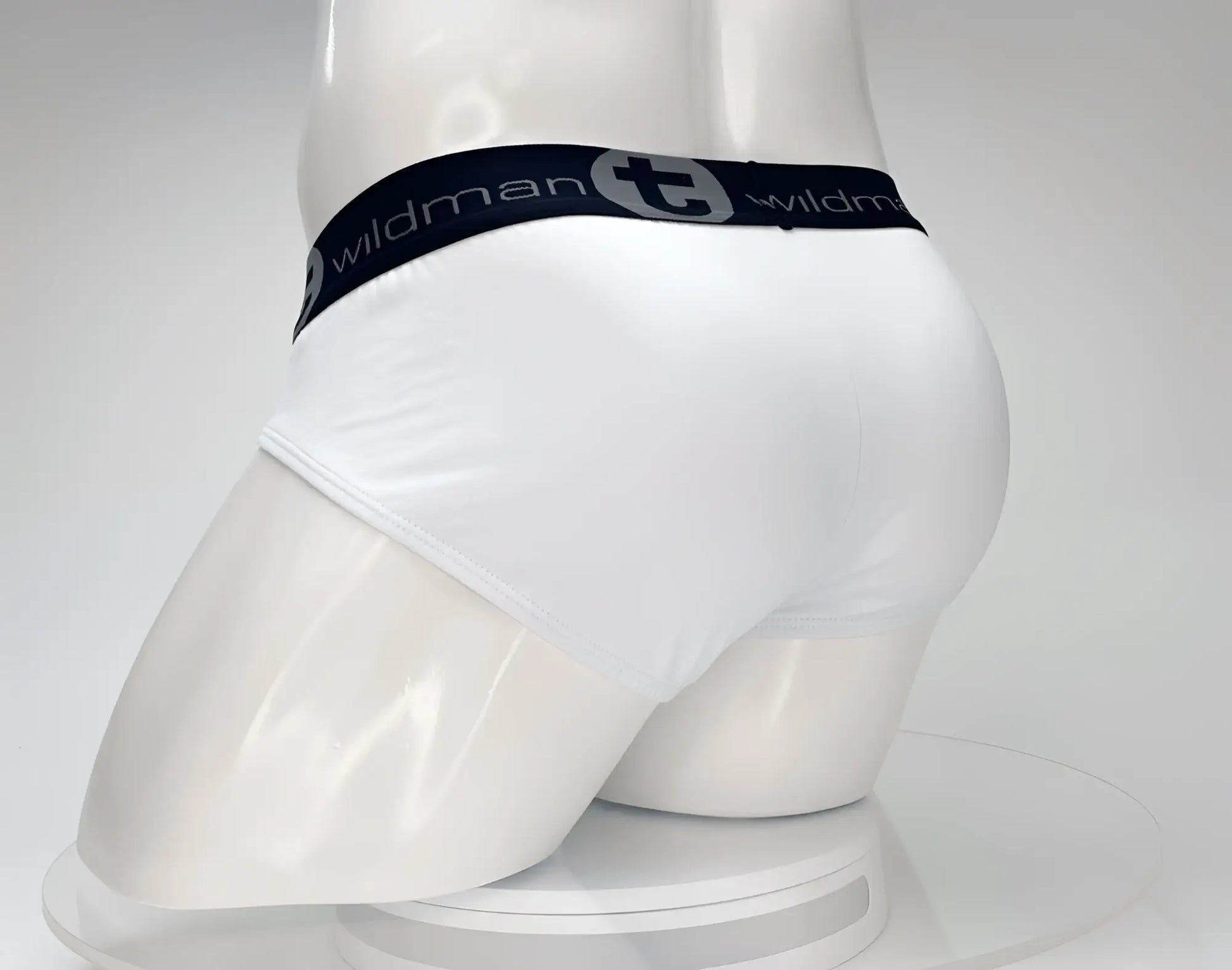 White men’s cotton briefs with black elastic waistband featuring wildman logo in gray wildmant cotton monster cock brief white