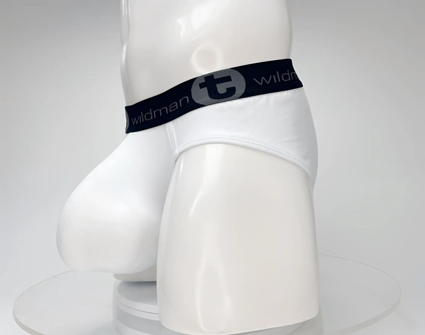 White men’s cotton briefs with a black elastic waistband featuring the wildman logo and text wildmant cotton monster cock brief white