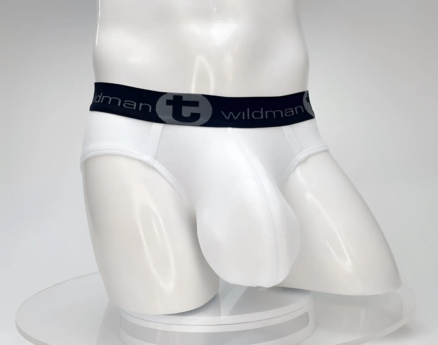 White mens cotton briefs with black elastic waistband featuring wildman brand logo and circular emblem
