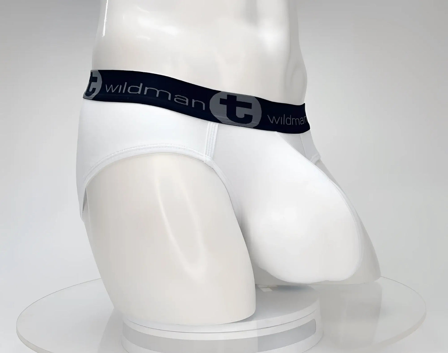 White men’s cotton briefs with black elastic waistband featuring wildman brand name and logo in gray