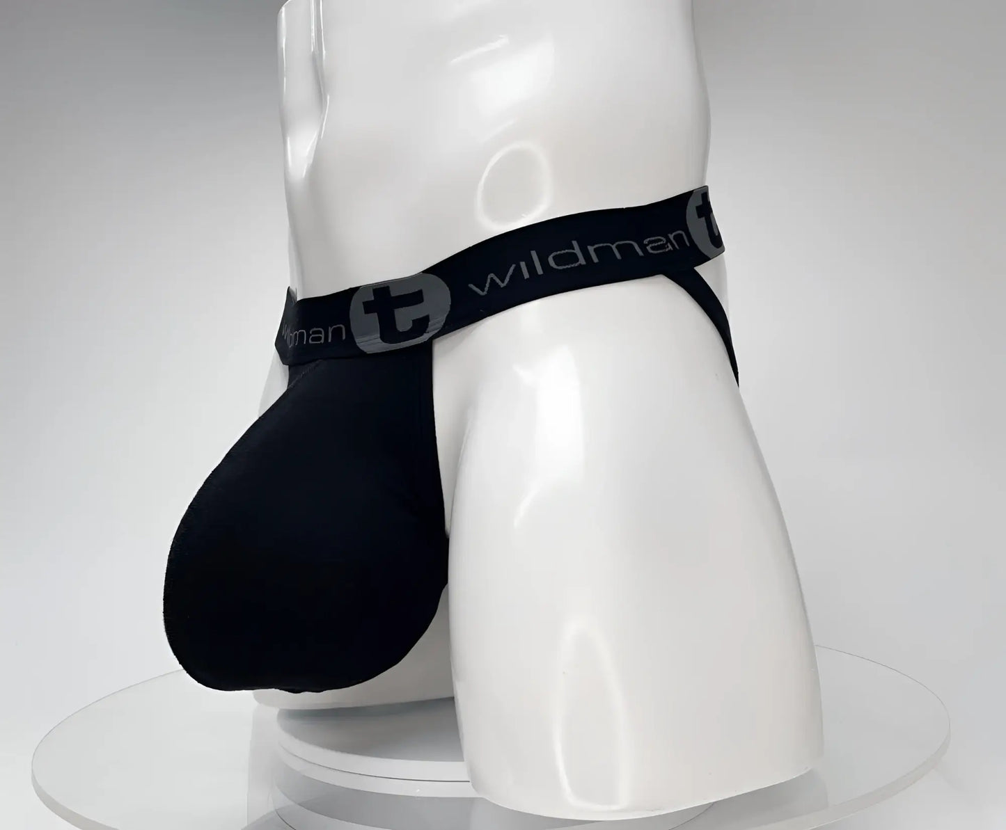 Black cotton jockstrap with a large pouch, shown on a white mannequin featuring a branded elastic waistband.