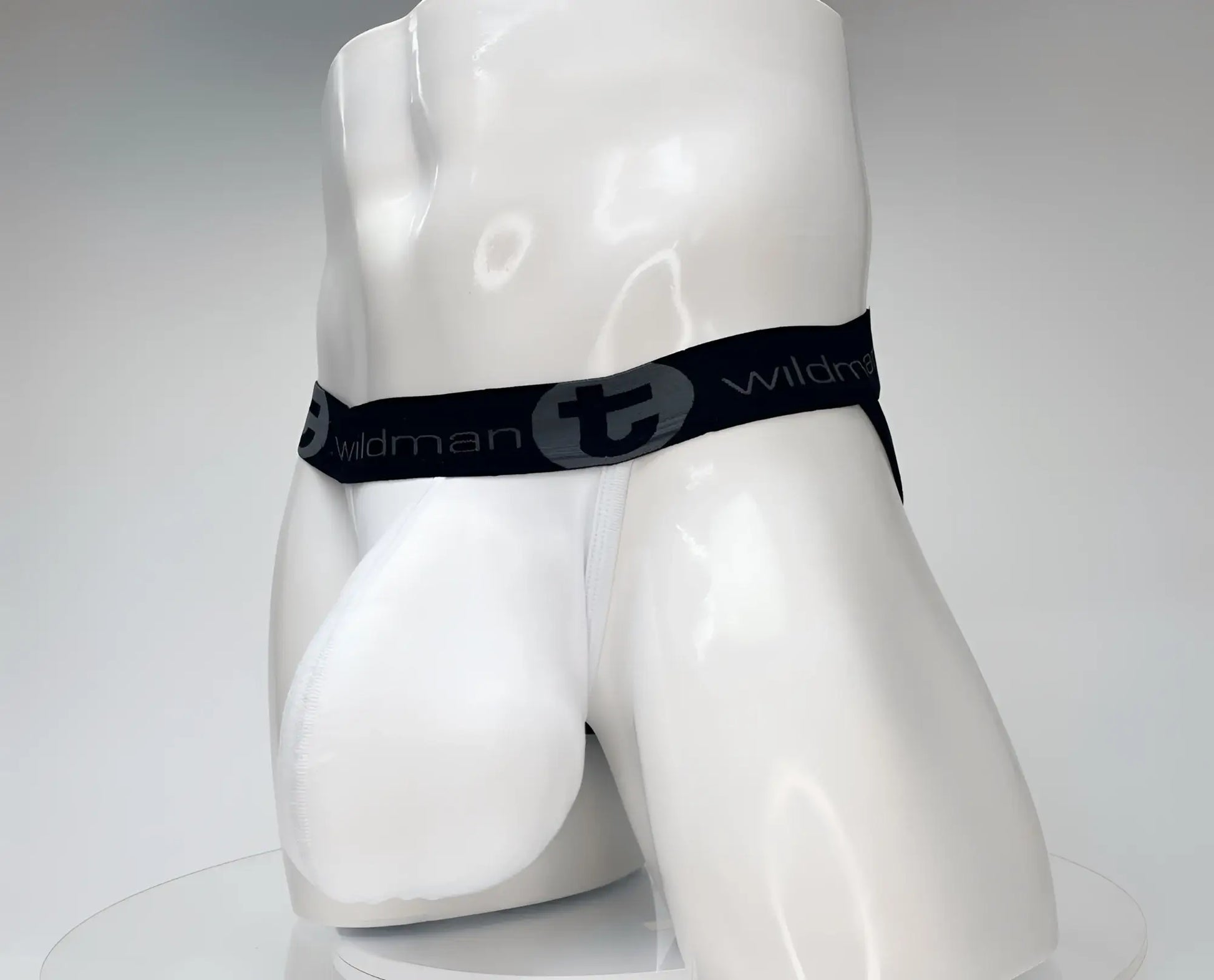 Wildmant cotton monster cock jockstrap white with black elastic waistband and wildman branding on white mannequin