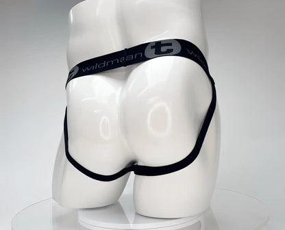 Black elastic waistband with wildman branding on a white cotton wildmant cotton monster cock jockstrap displayed on mannequin