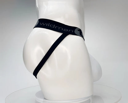 Black wildman brand white cotton thong with sleek minimalist design and elastic waistband shown from the back side