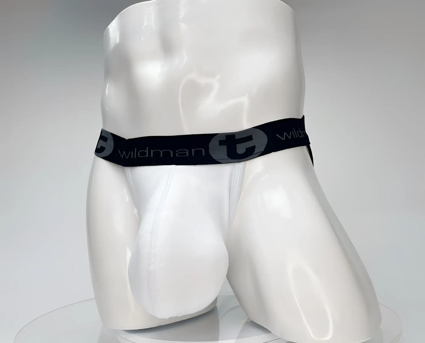 White men’s cotton briefs with black elastic waistband featuring wildman logo and stylized t emblem wildmant cotton monster cock jockstrap white