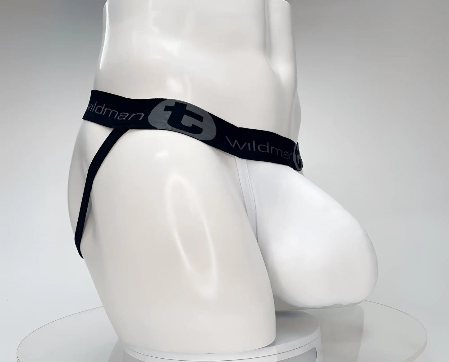 White men’s cotton thong with black elastic waistband and wildman branding featuring a gray logo