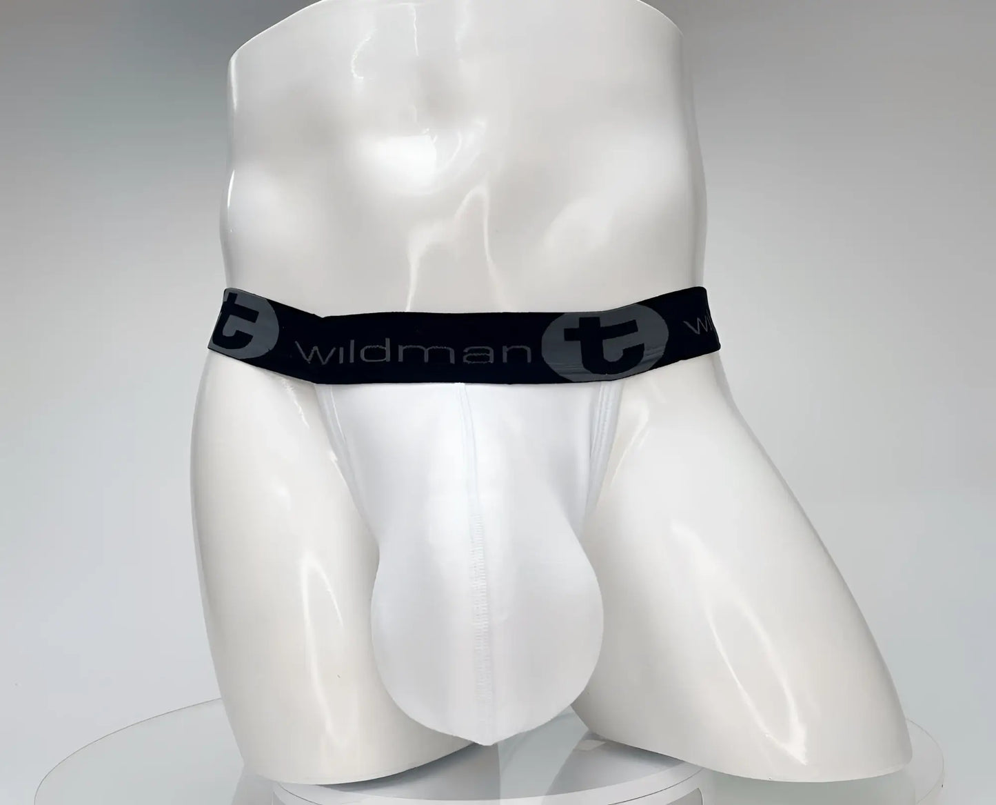 White wildman cotton monster cock jockstrap briefs with black elastic waistband featuring wildman logo and stylized t emblem