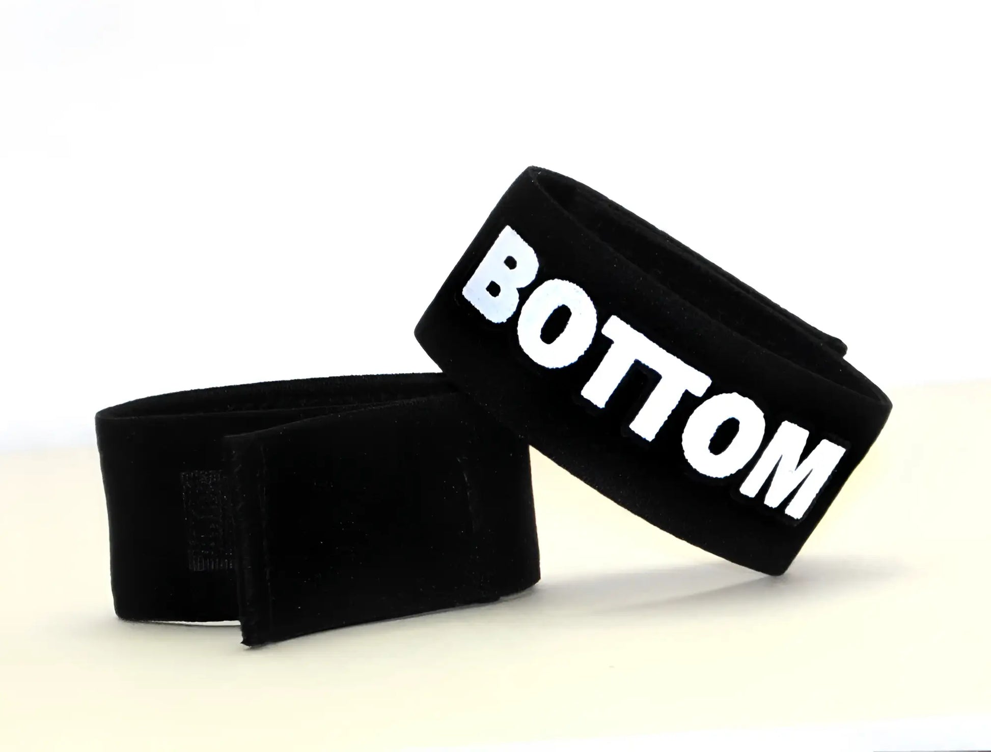 Black velour wristband with bold white bottom lettering from wildmant fetish max cock-ring bottom collection