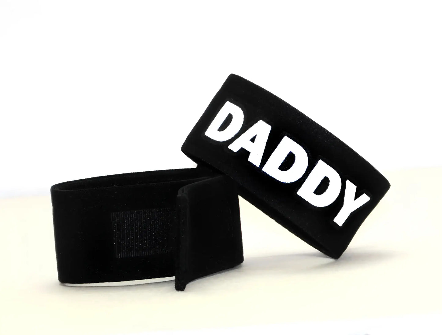 Black velour wristband with bold white daddy lettering from wildmant fetish max cock ring daddy collection
