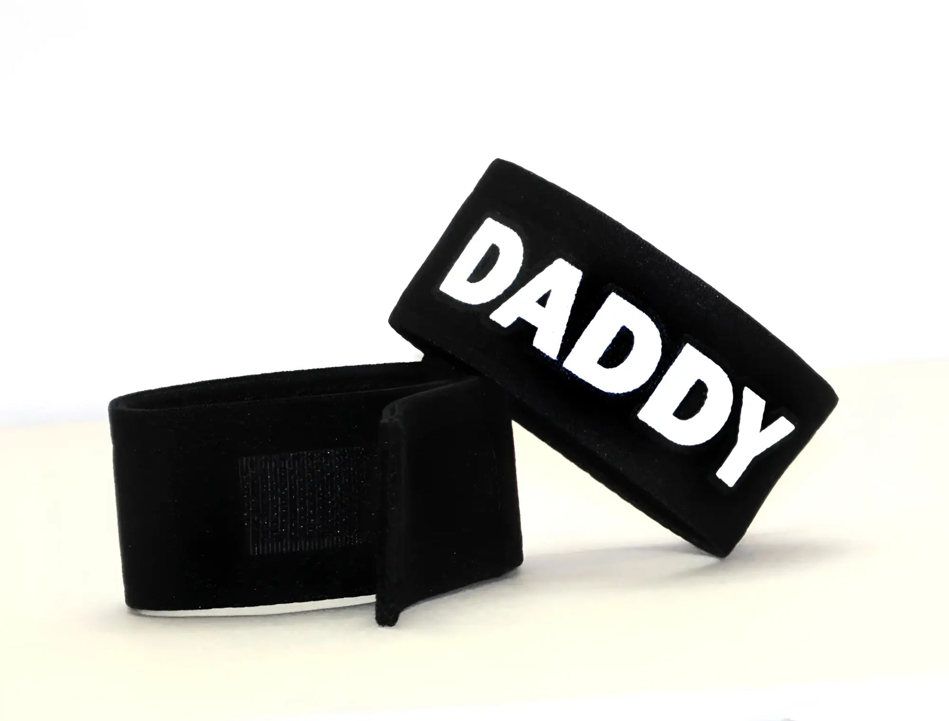 Black velour wristband with bold white daddy lettering from wildmant fetish max cock ring daddy collection