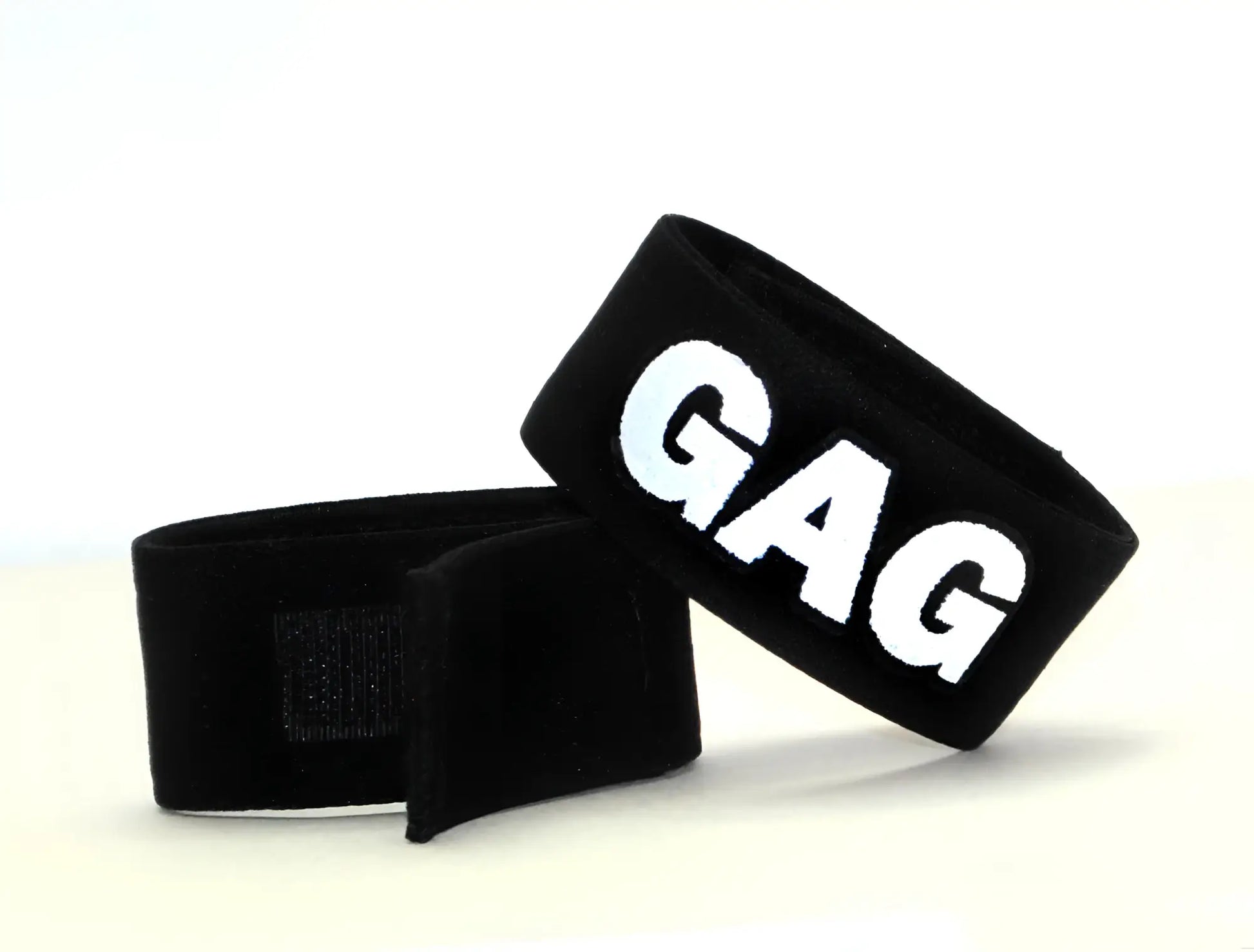Black elastic velcro strap with the word "GAG" in bold white letters, shown in a pair on a white background.