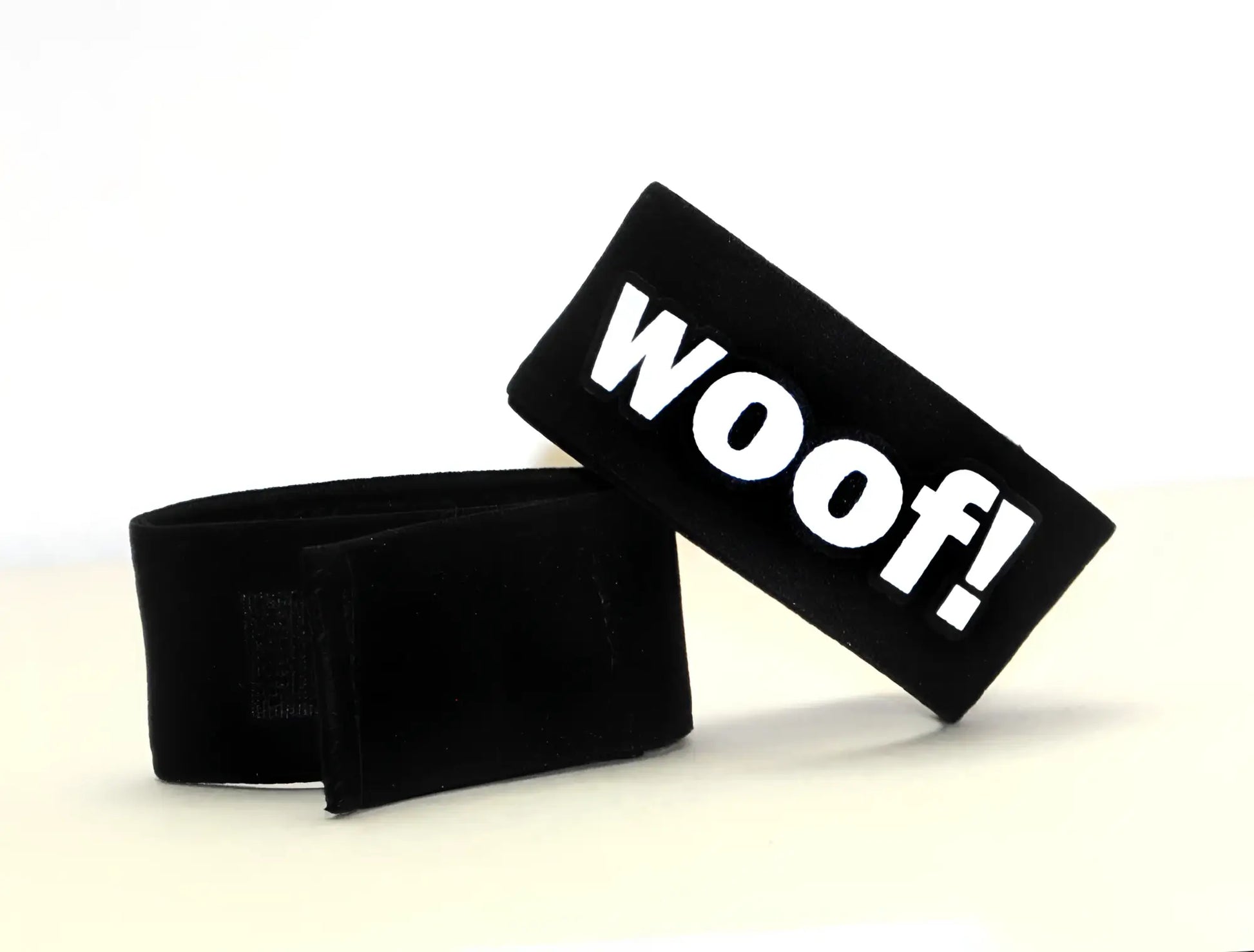 Black velour pet collar strap with bold white woof lettering for wildmant fetish max cock-ring-woof product