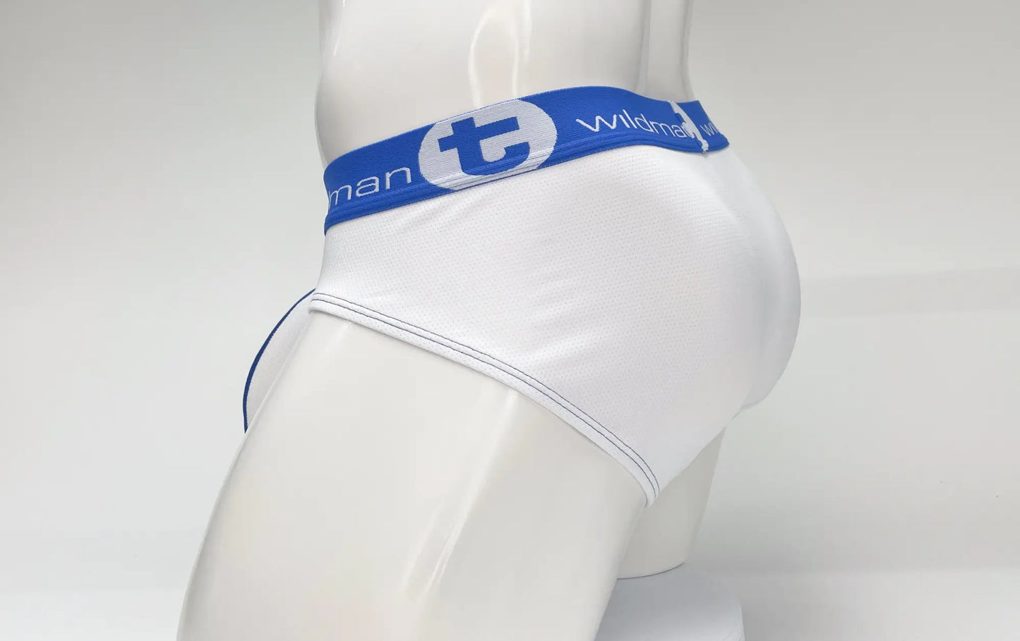 White men’s mesh briefs with blue elastic waistband featuring wildman logo and big boy pouch stripe design