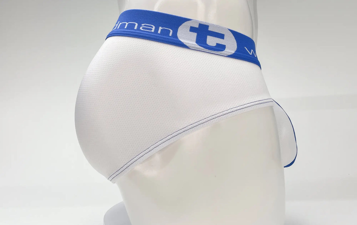White wildmant mesh big boy pouch brief with blue elastic waistband and navy stitched edges featuring t logo