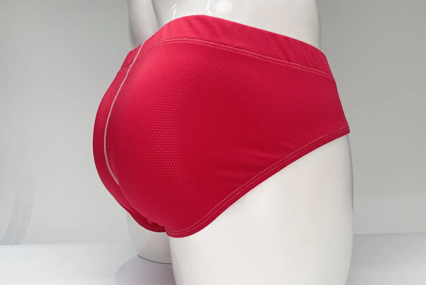Wildmant mesh brief red featuring red athletic briefs with mesh texture and white stitching along the seams