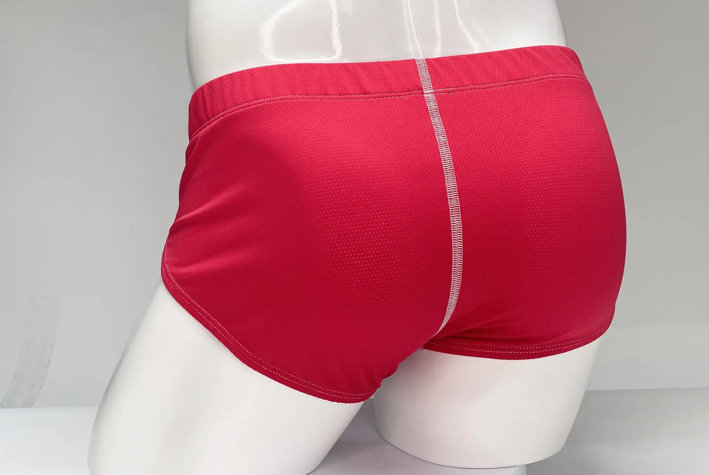 Wildmant mesh brief red athletic briefs in textured red mesh fabric with white stitching along center seam