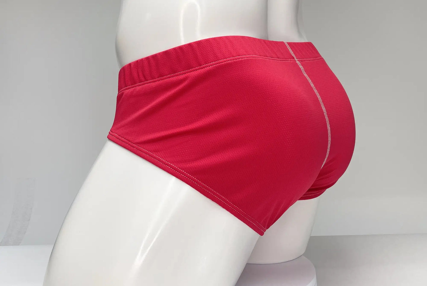 Red wildmant mesh brief with bright red snug fit and white stitching along the waistband