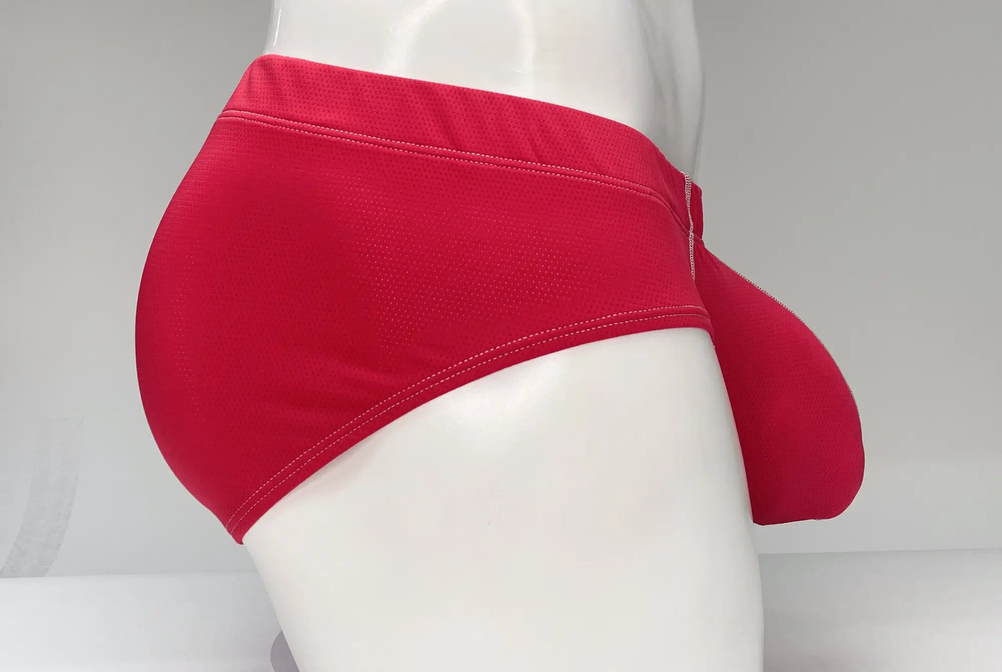 Bright red wildmant mesh brief with smooth fabric and visible stitching along the waistband for men
