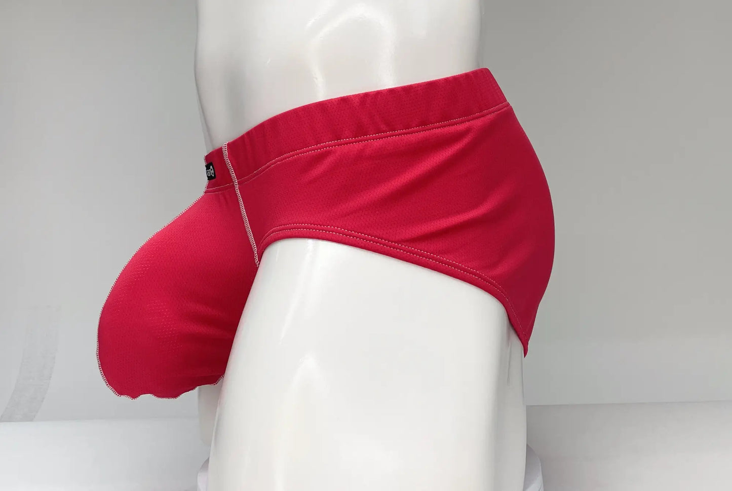 Wildmant mesh brief red bright red form-fitting swim trunks with smooth fabric and subtle stitching details