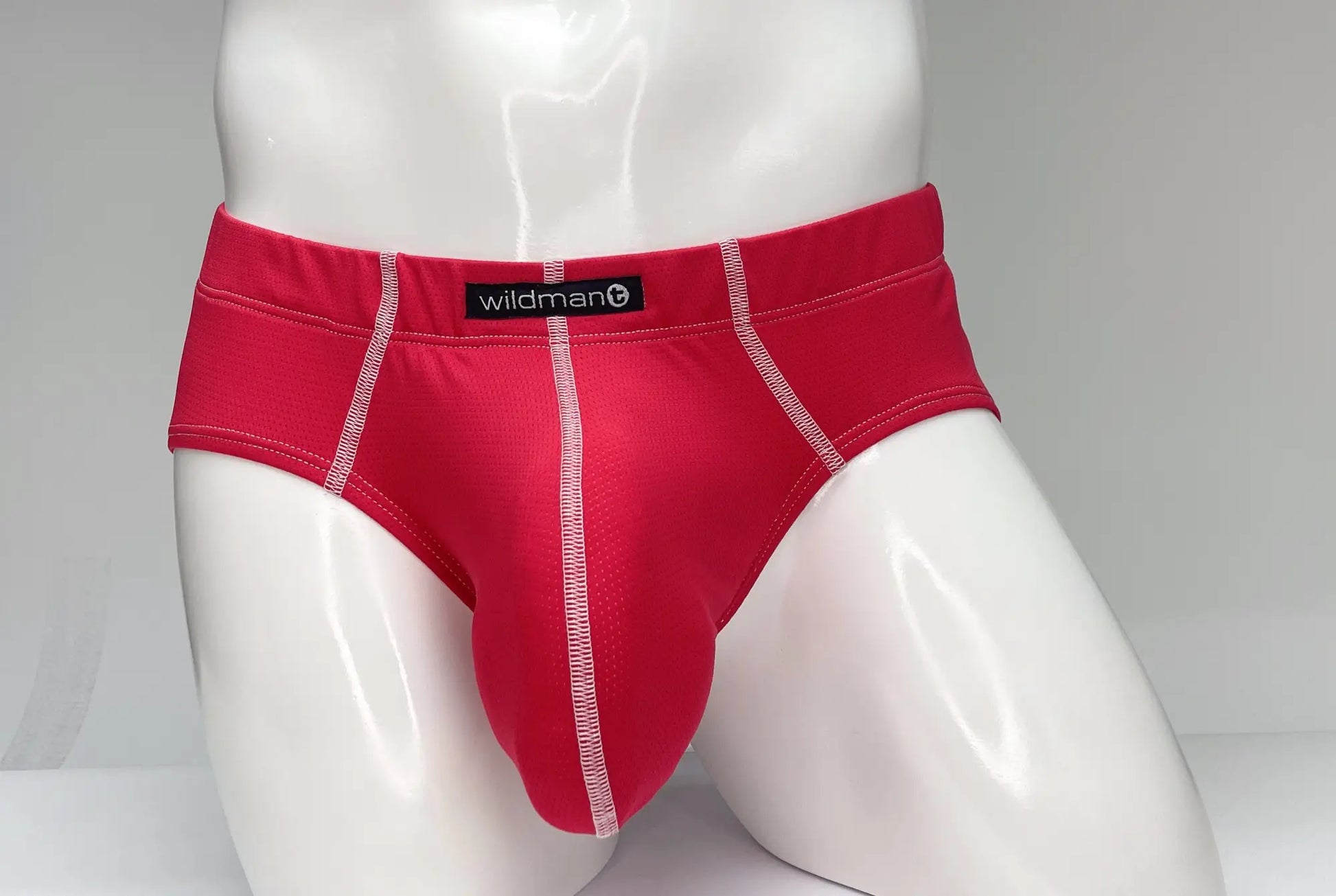 Wildmant mesh brief red in red with white stitching and a black label made for breathable comfort