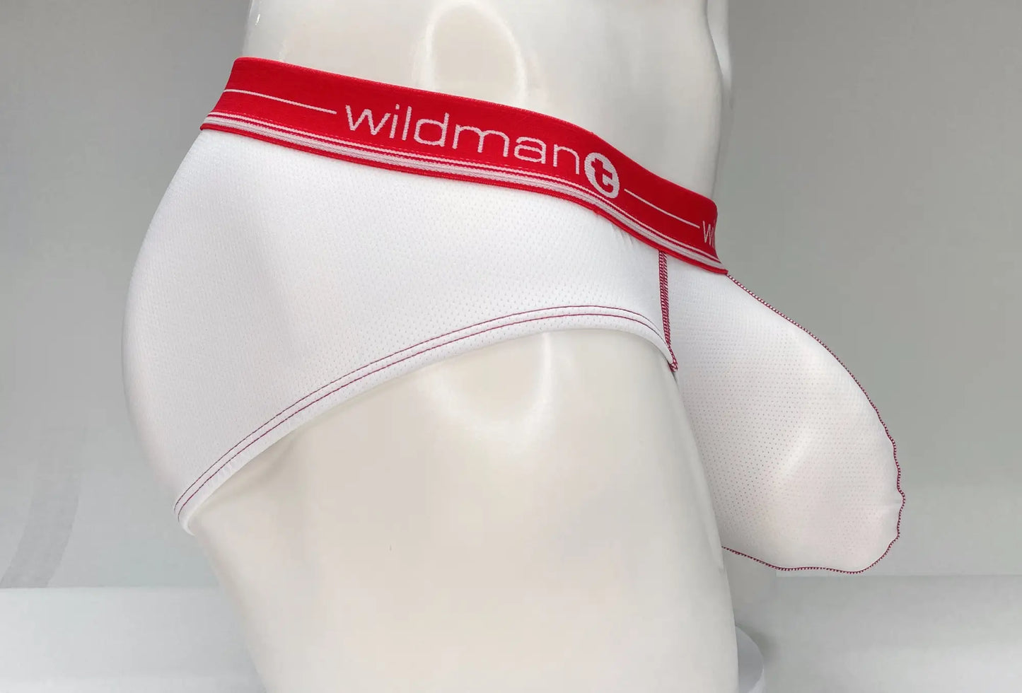 White men’s mesh briefs with a red waistband featuring the wildman brand name and logo