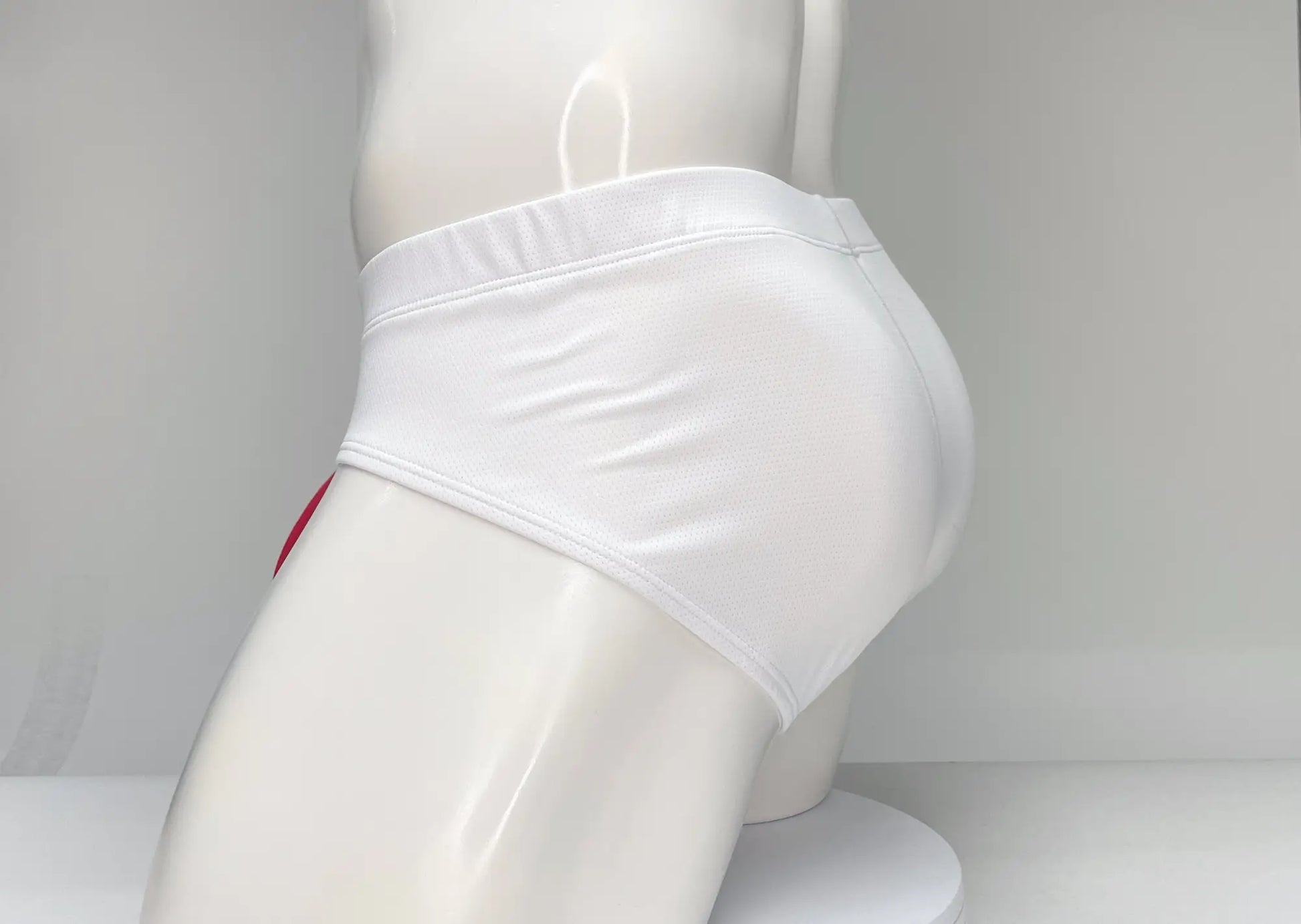 WildmanT mesh brief white with smooth form-fitting design and subtle red trim along the side seam