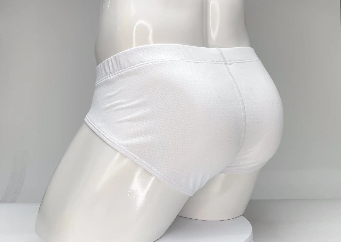 Wildmant mesh brief white and red white briefs with smooth form fitting fabric and elastic waistband shown from the back