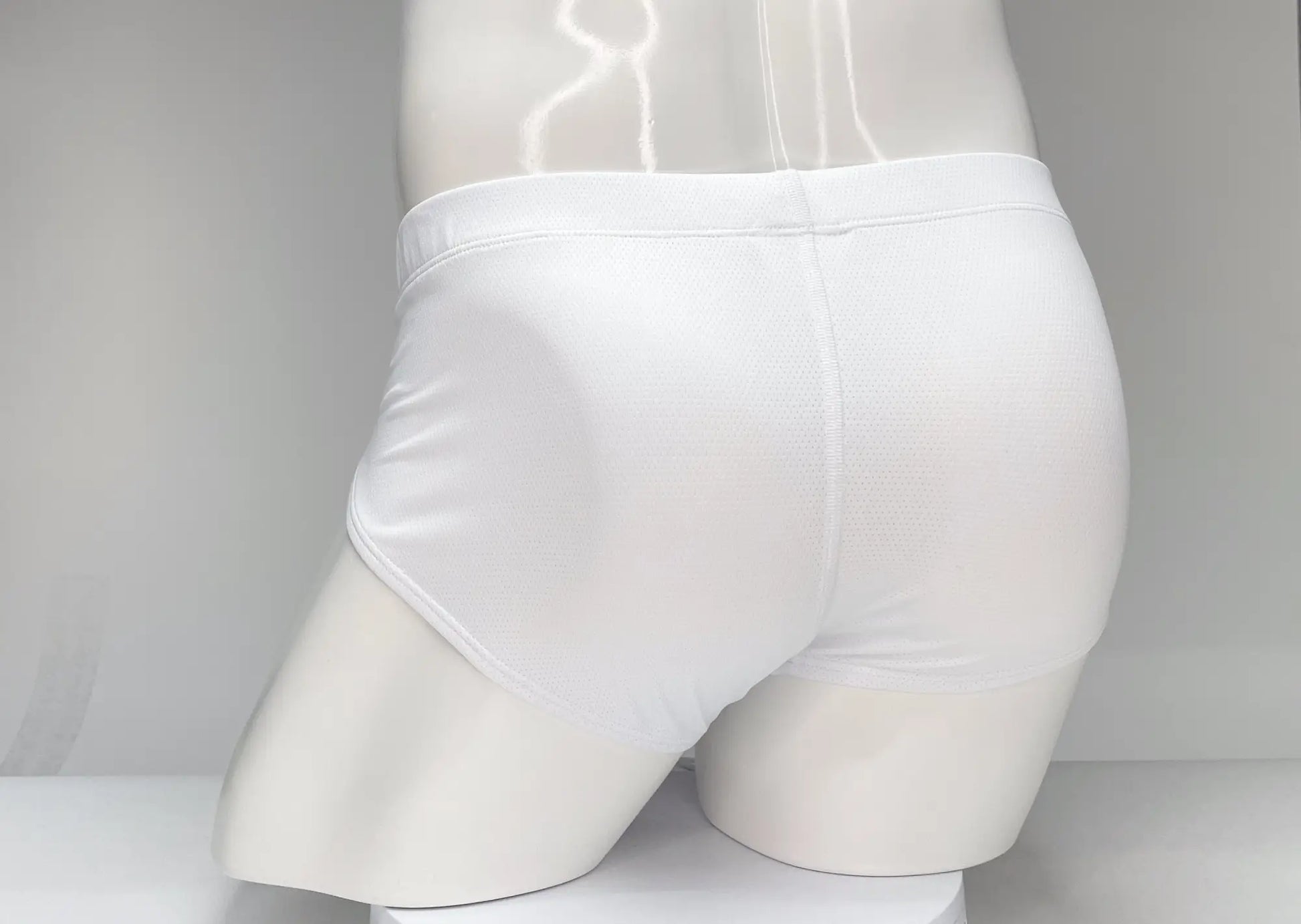 White wildmant mesh brief with smooth form fitting fabric and subtle seam detailing in front view