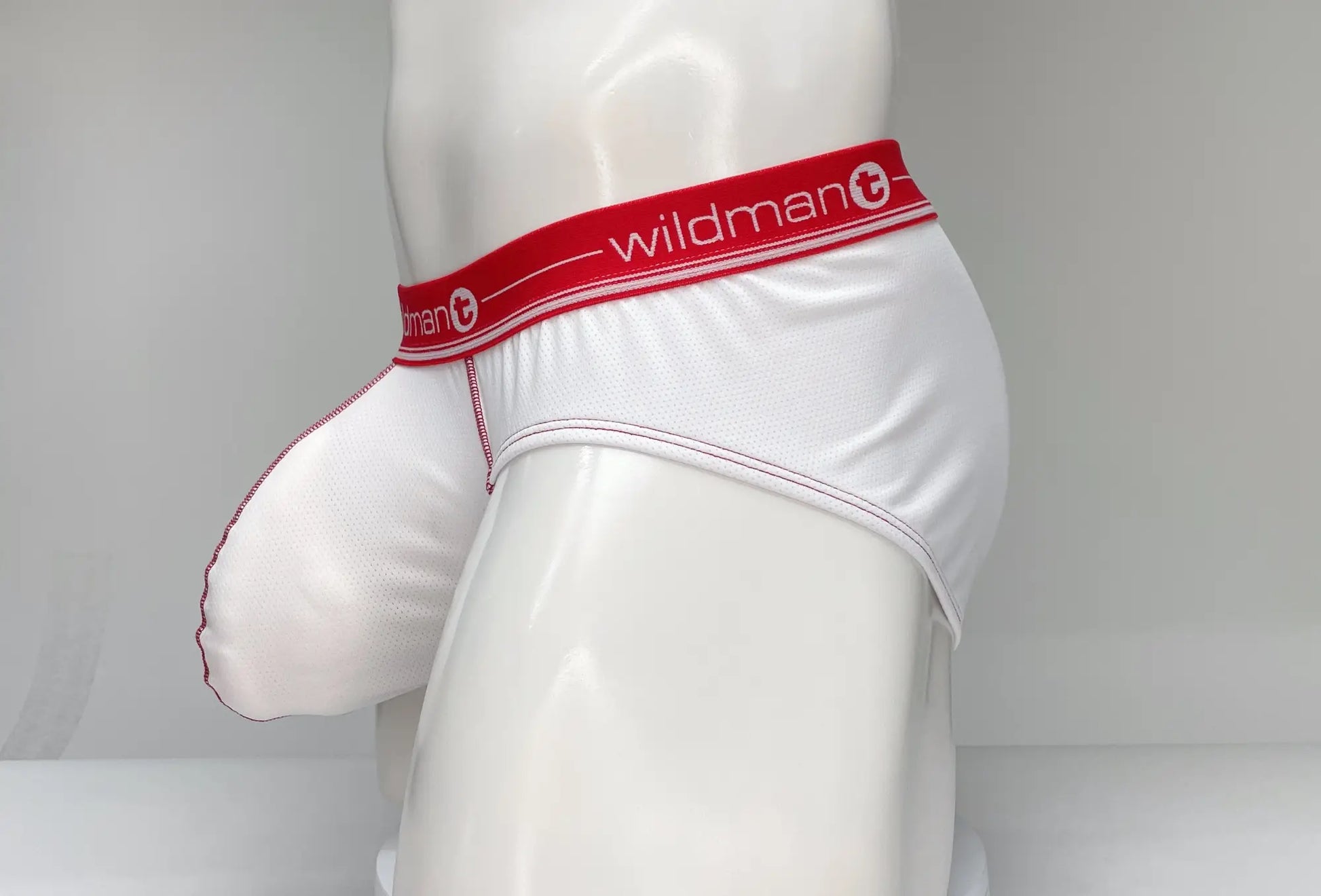 White wildman men’s mesh briefs with red waistband featuring the brand logo for breathable comfort