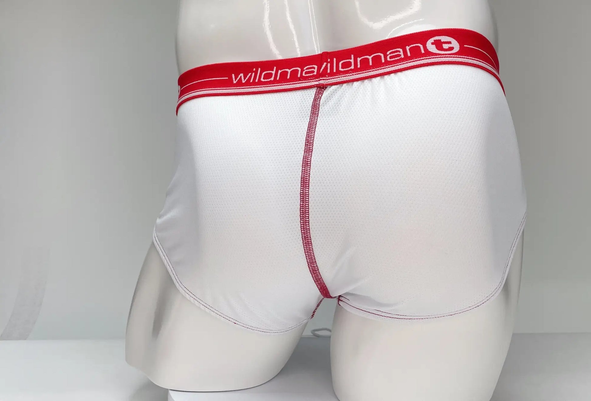 WildmanT mesh briefs in white with red waistband logo and matching red center seam stitching