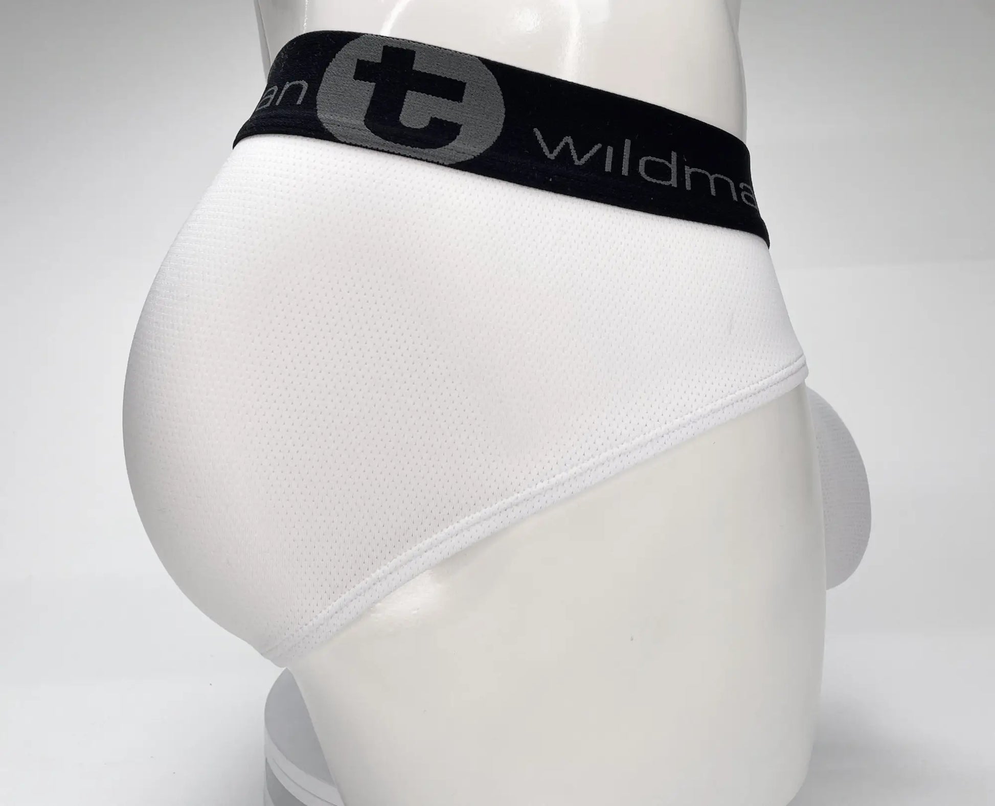 White briefs with black elastic waistband featuring the wildmant logo in mesh material wildmant mesh monster cock brief white