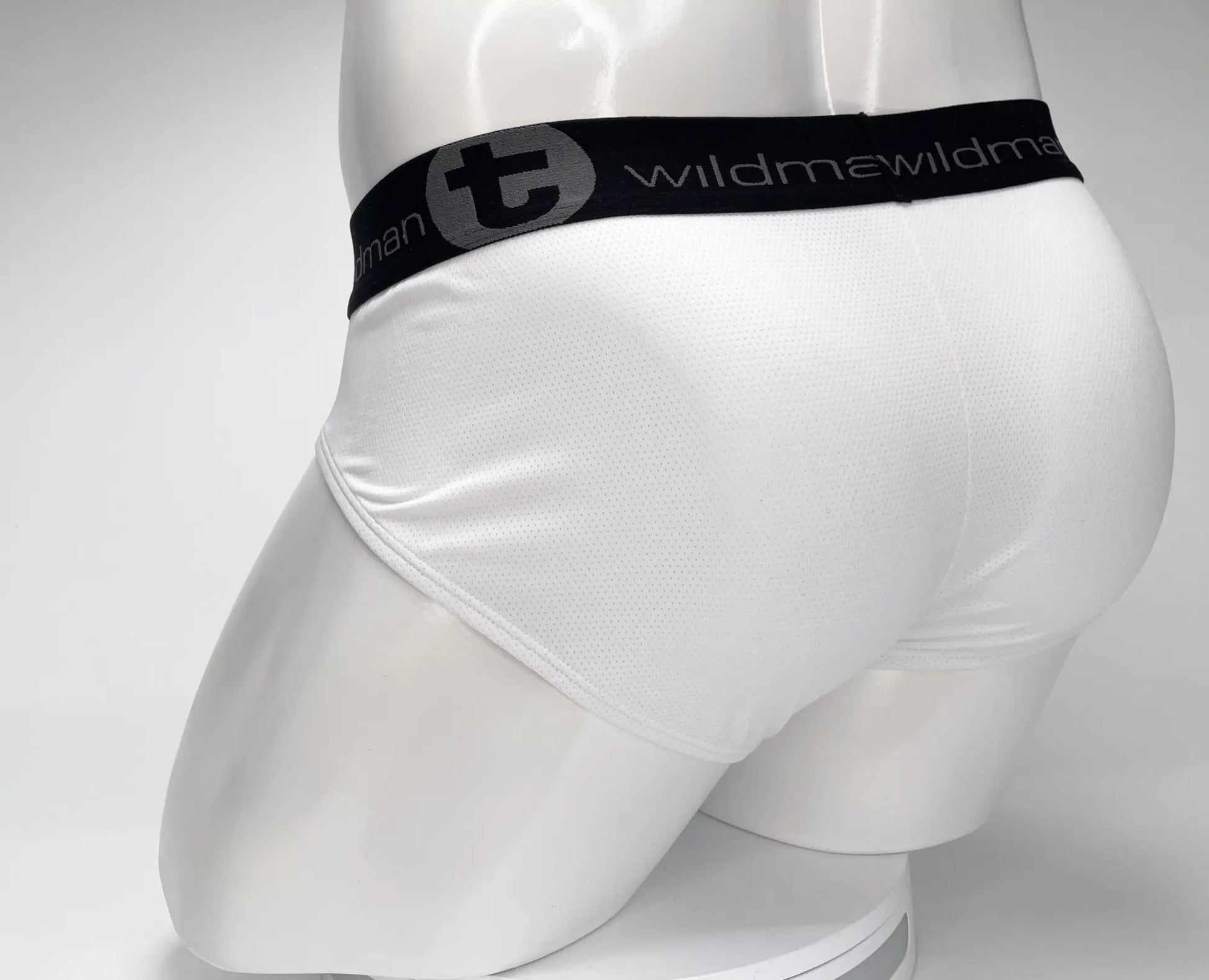 White men’s briefs with black elastic waistband featuring wildman logo mesh material for breathable comfort